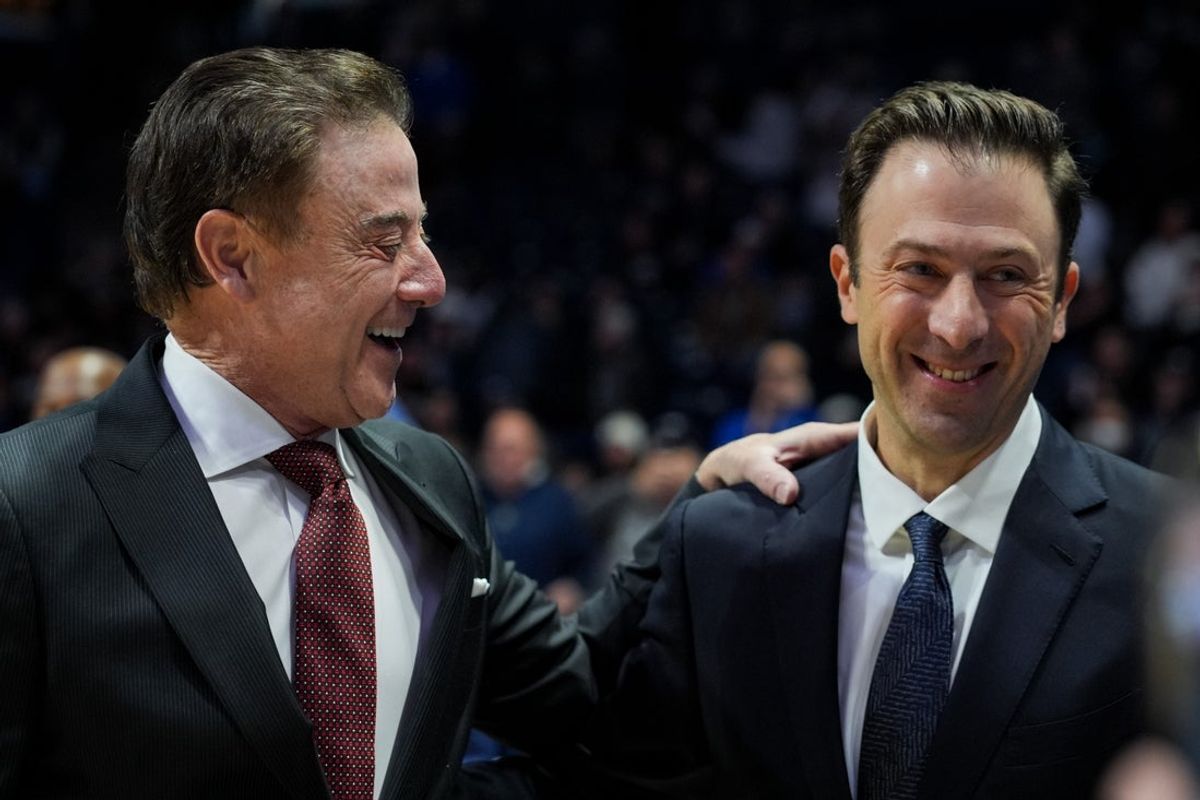 Jan 24, 2026; Cincinnati, Ohio, USA;  St. John's Red Storm head coach Rick Pitino, left, talks with Xavier Musketeers head coach Richard Pitino, right, before their game at the Cintas Center. Mandatory Credit: Aaron Doster-Imagn Images
