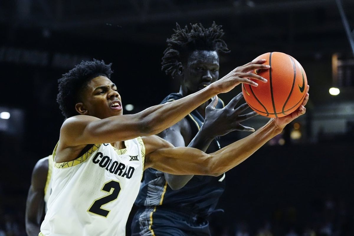 Jan 24, 2026; Boulder, Colorado, USA;  UCF Knights guard Riley Kugel (2) steals a pass intended for UCF Knights center John Bol (7) in the first half at the CU Events Center. Mandatory Credit: Ron Chenoy-Imagn Images