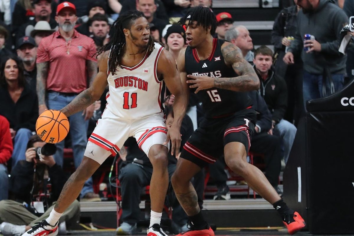 Jan 24, 2026; Lubbock, Texas, USA;  Houston Cougars forward Joseph Tugler (11) works the ball against Texas Tech Red Raiders forward JT Toppin (15) in the first half at United Supermarkets Arena. Mandatory Credit: Michael C. Johnson-Imagn Images