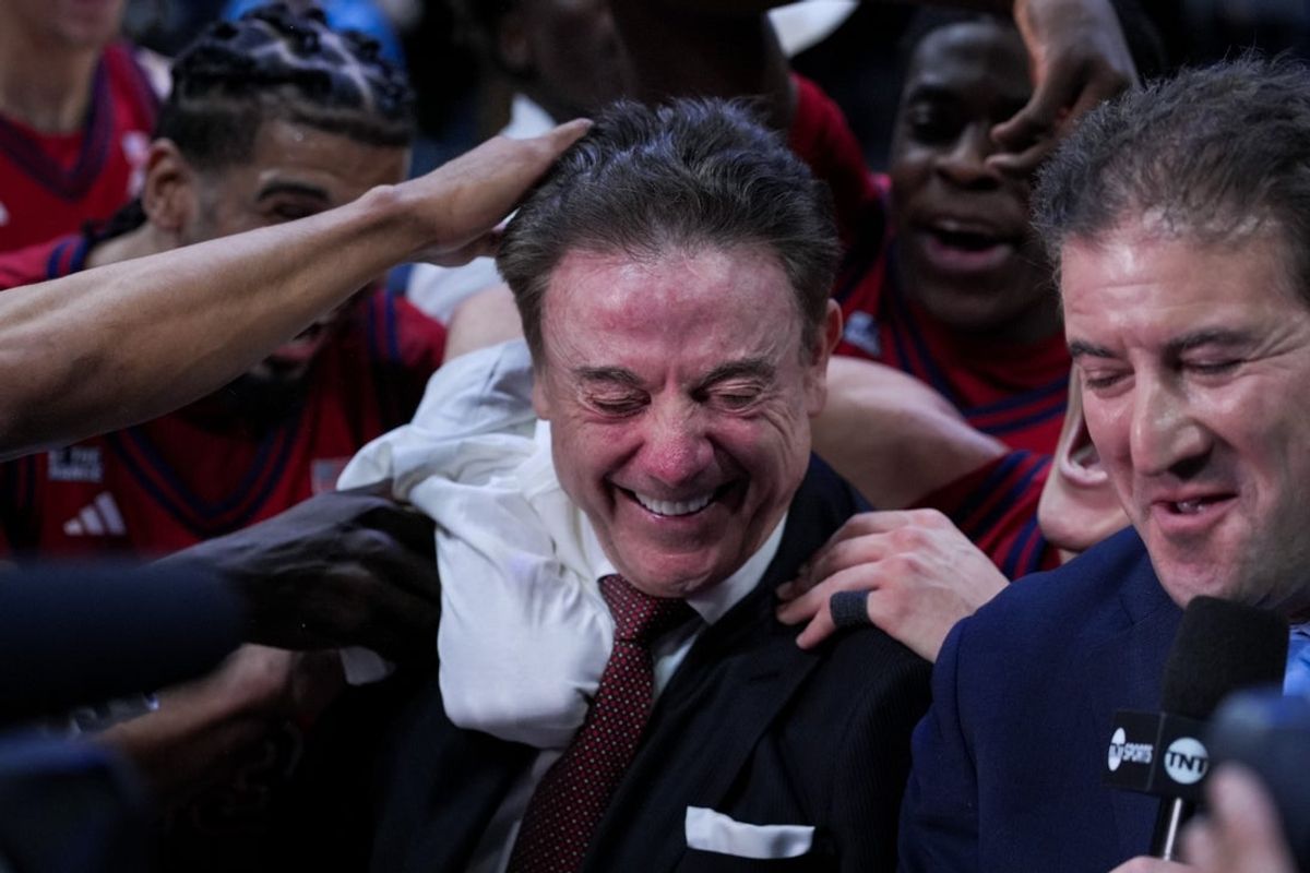 Jan 24, 2026; Cincinnati, Ohio, USA;  St. John's Red Storm head coach Rick Pitino is mobbed by his team after defeating the Xavier Musketeers at the Cintas Center. The win is the 900th of Pitino’s career. Mandatory Credit: Aaron Doster-Imagn Images