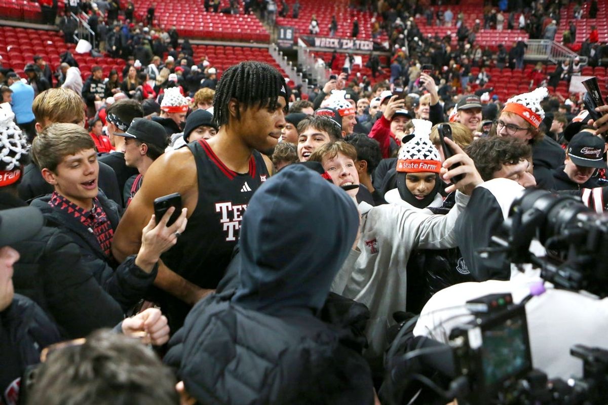 Jan 24, 2026; Lubbock, Texas, USA;  Texas Tech Red Raiders forward JT Toppin (15) is surrounded by members of the Texas Tech Red Raiders student body after the game against the Houston Cougars at United Supermarkets Arena. Mandatory Credit: Michael C. Johnson-Imagn Images