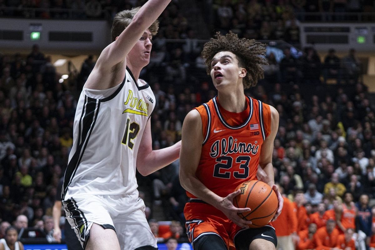 Jan 24, 2026; West Lafayette, Indiana, USA; Illinois Fighting Illini guard Keaton Wagler (23) dribbles past Purdue Boilermakers center Daniel Jacobsen (12) during the first half at Mackey Arena. Mandatory Credit: Jacob Musselman-Imagn Images