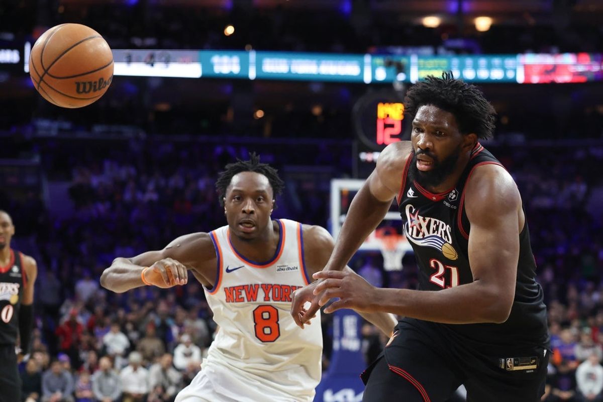 Jan 24, 2026; Philadelphia, Pennsylvania, USA; Philadelphia 76ers center Joel Embiid (21) chases a loose bal in front of New York Knicks forward Og Anunoby (8) during the fourth quarter at Xfinity Mobile Arena. Mandatory Credit: Bill Streicher-Imagn Images
