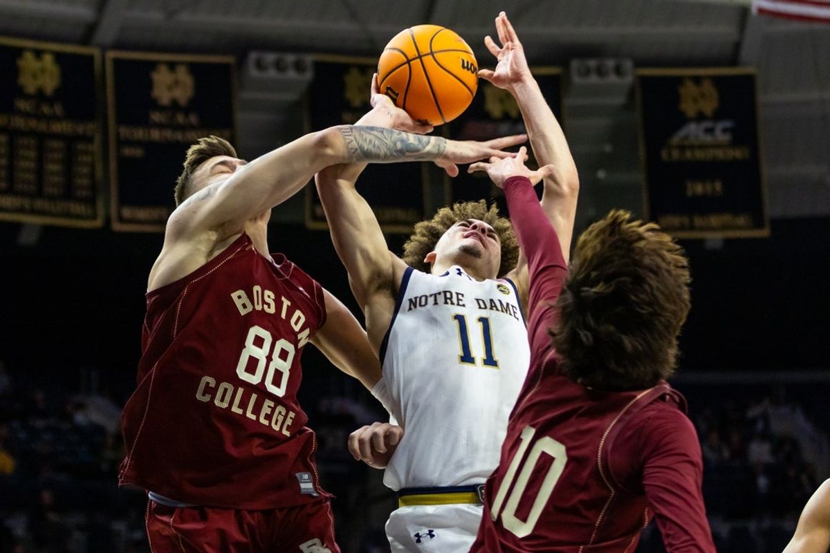 Jan 24, 2026; South Bend, Indiana, USA; Notre Dame Fighting Irish guard Braeden Shrewsberry (11) drives to the basket as Boston College Eagles forward Marko Radunovic (88) and Boston College Eagles guard Luka Toews (10) defend during the first half at Purcell Pavilion at the Joyce Center. Mandatory Credit: Michael Caterina-Imagn Images