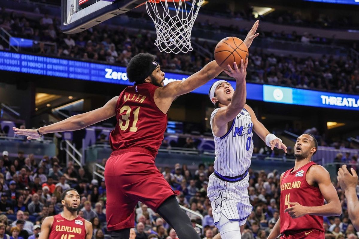 Jan 24, 2026; Orlando, Florida, USA; Orlando Magic guard Anthony Black (0) goes to the basket against Cleveland Cavaliers center Jarrett Allen (31) during the first quarter at Kia Center. Mandatory Credit: Mike Watters-Imagn Images