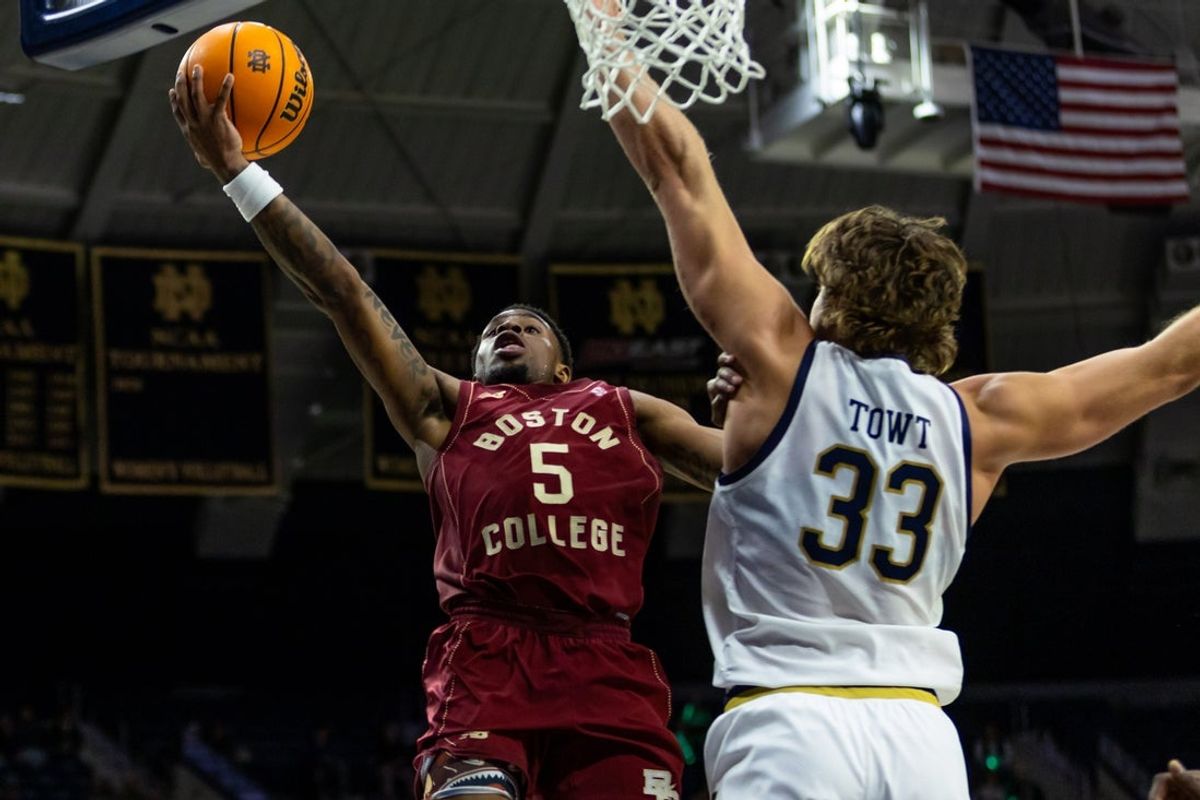 Jan 24, 2026; South Bend, Indiana, USA; Boston College Eagles guard Fred Payne (5) drives as Notre Dame Fighting Irish forward Carson Towt (33) defends during the second half at Purcell Pavilion at the Joyce Center. Mandatory Credit: Michael Caterina-Imagn Images