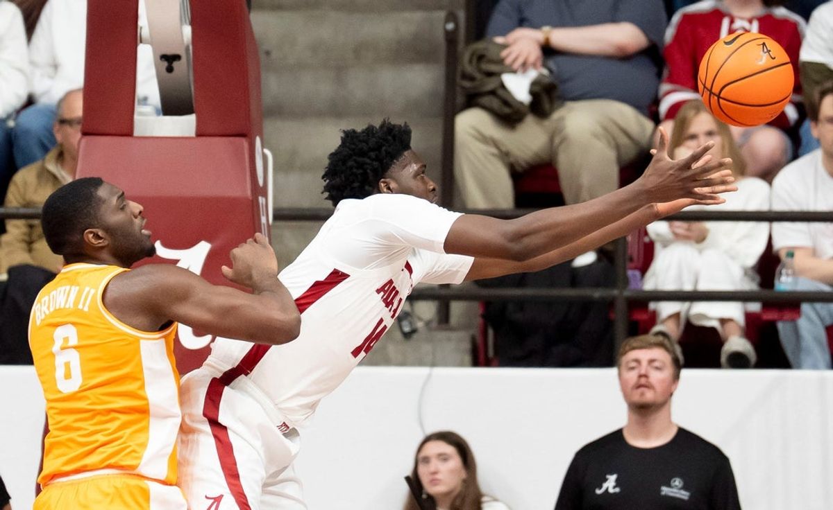 Jan 24, 2026; Tuscaloosa, AL, USA; Alabama center Charles Bediako (14) reaches out to grab a rebound against Tennessee forward Dewayne Brown II (6) at Coleman Coliseum. Mandatory Credit: Gary Cosby Jr.-Tuscaloosa News