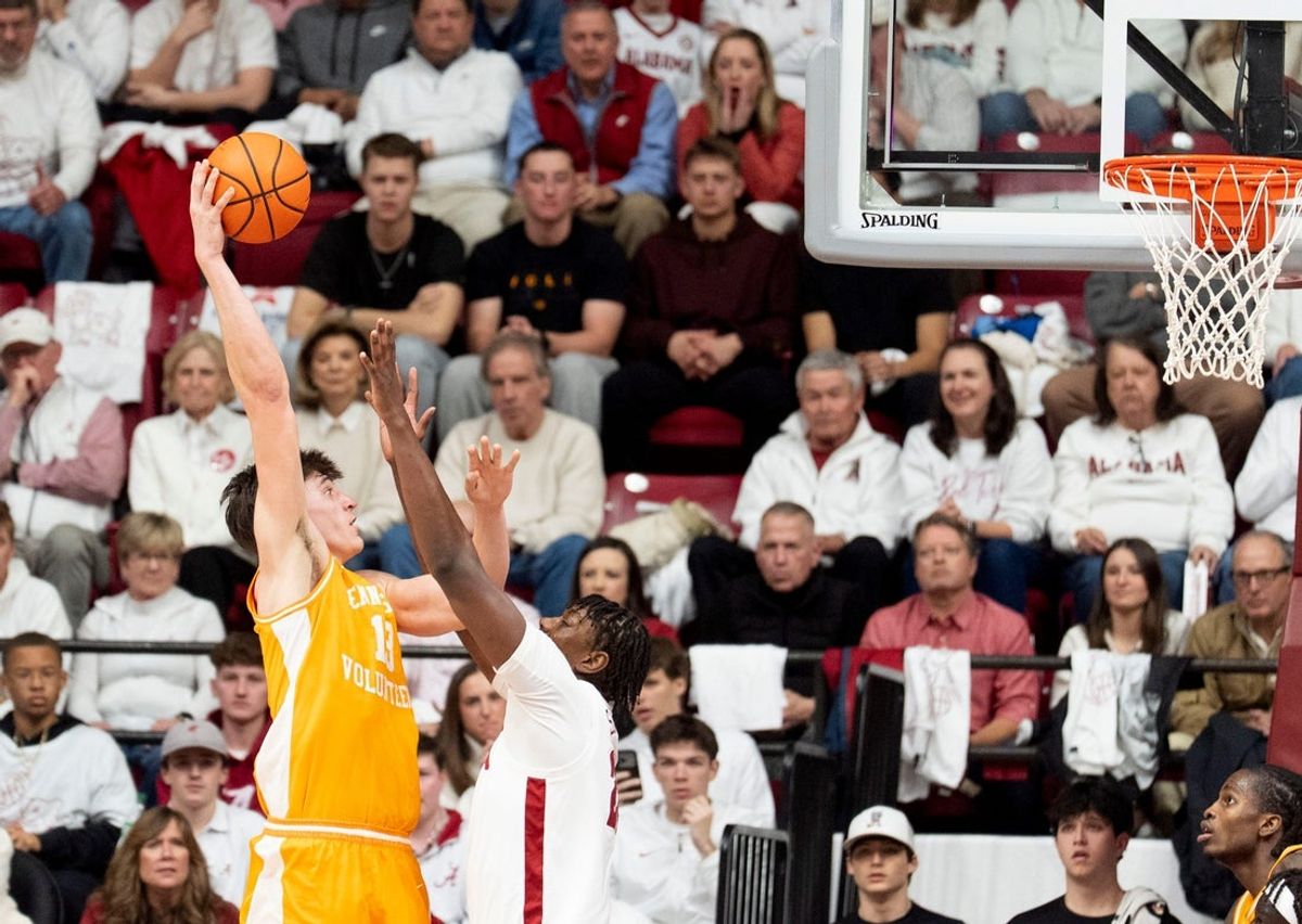 Jan 24, 2026; Tuscaloosa, AL, USA; Tennessee forward J.P. Estrella (13) scores on a hook over Alabama forward Aiden Sherrell (22) at Coleman Coliseum. Mandatory Credit: Gary Cosby Jr.-Tuscaloosa News