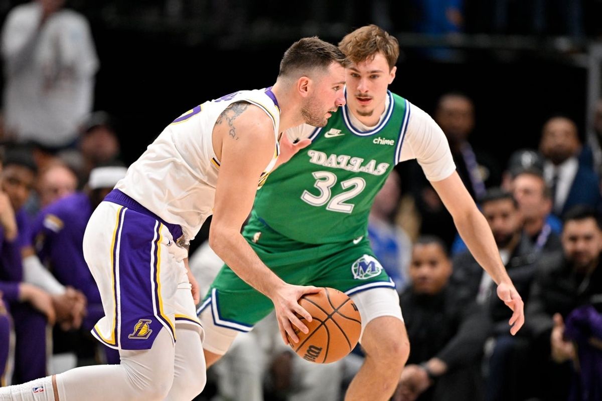 Jan 24, 2026; Dallas, Texas, USA; Los Angeles Lakers guard Luka Doncic (77) moves the ball to the basket past Dallas Mavericks forward Cooper Flagg (32) during the second quarter at the American Airlines Center. Mandatory Credit: Jerome Miron-Imagn Images