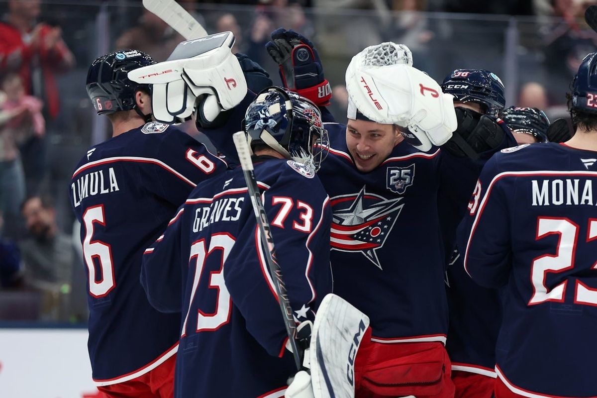 Jan 24, 2026; Columbus, Ohio, USA;  Columbus Blue Jackets goaltender Elvis Merzlikins (facing) celebrates with Columbus Blue Jackets goaltender Jet Greaves (73) following the game against the Tampa Bay Lightning at Nationwide Arena. Mandatory Credit: Joseph Maiorana-Imagn Images