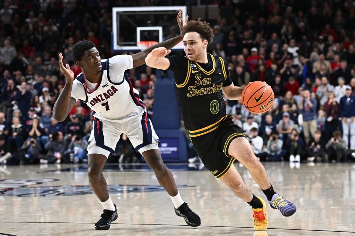 Jan 24, 2026; Spokane, Washington, USA; San Francisco Dons guard Ryan Beasley (0) runs the lane against Gonzaga Bulldogs guard Tyon Grant-Foster (7) in the second half at McCarthey Athletic Center. Gonzaga Bulldogs won 68-66. Mandatory Credit: James Snook-Imagn Images