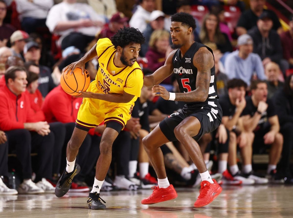 Jan 24, 2026; Tempe, Arizona, USA; Arizona State Sun Devils guard Maurice Odum (left) controls the ball against Cincinnati Bearcats guard Sencire Harris in the first half at Desert Financial Arena. Mandatory Credit: Mark J. Rebilas-Imagn Images