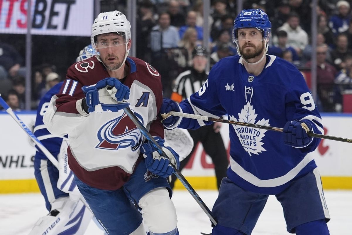 Jan 25, 2026; Toronto, Ontario, CAN; Colorado Avalanche forward Brock Nelson (11) and Toronto Maple Leafs defenseman Oliver Ekman-Larsson (95) look for the puck during the second period at Scotiabank Arena. Mandatory Credit: John E. Sokolowski-Imagn Images