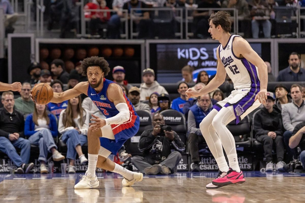Jan 25, 2026; Detroit, Michigan, USA; Detroit Pistons guard Cade Cunningham (2) keeps the ball inbounds in front of Sacramento Kings center Maxime Raynaud (42) during the first half at Little Caesars Arena. Mandatory Credit: David Reginek-Imagn Images