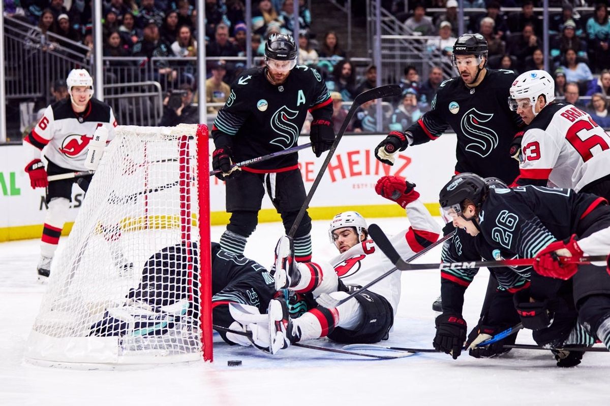 Jan 25, 2026; Seattle, Washington, USA; New Jersey Devils center Nico Hischier (13) attempts to score as Seattle Kraken goaltender Joey Daccord (35) blocks the shot during the second period at Climate Pledge Arena. Mandatory Credit: Blake Dahlin-Imagn Images
