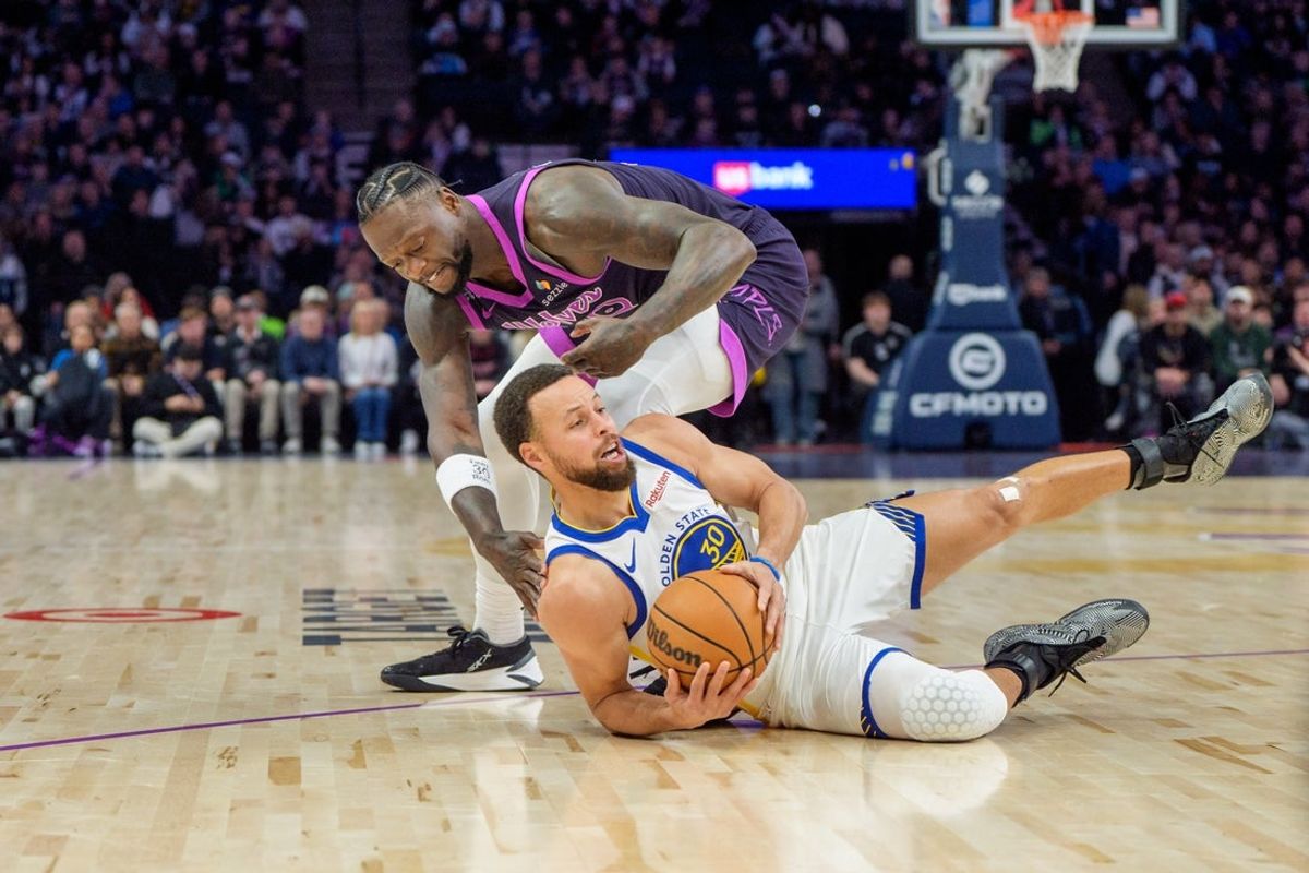 Jan 25, 2026; Minneapolis, Minnesota, USA; Golden State Warriors guard Stephen Curry (30) dives for a loose ball in front of Minnesota Timberwolves forward Julius Randle (30) in the first quarter at Target Center. Mandatory Credit: Matt Blewett-Imagn Images
