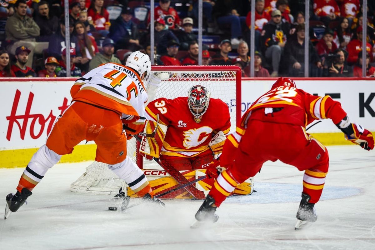 Jan 25, 2026; Calgary, Alberta, CAN; Calgary Flames goaltender Dustin Wolf (32) guards his net against Anaheim Ducks right wing Beckett Sennecke (45) during the first period at Scotiabank Saddledome. Mandatory Credit: Sergei Belski-Imagn Images