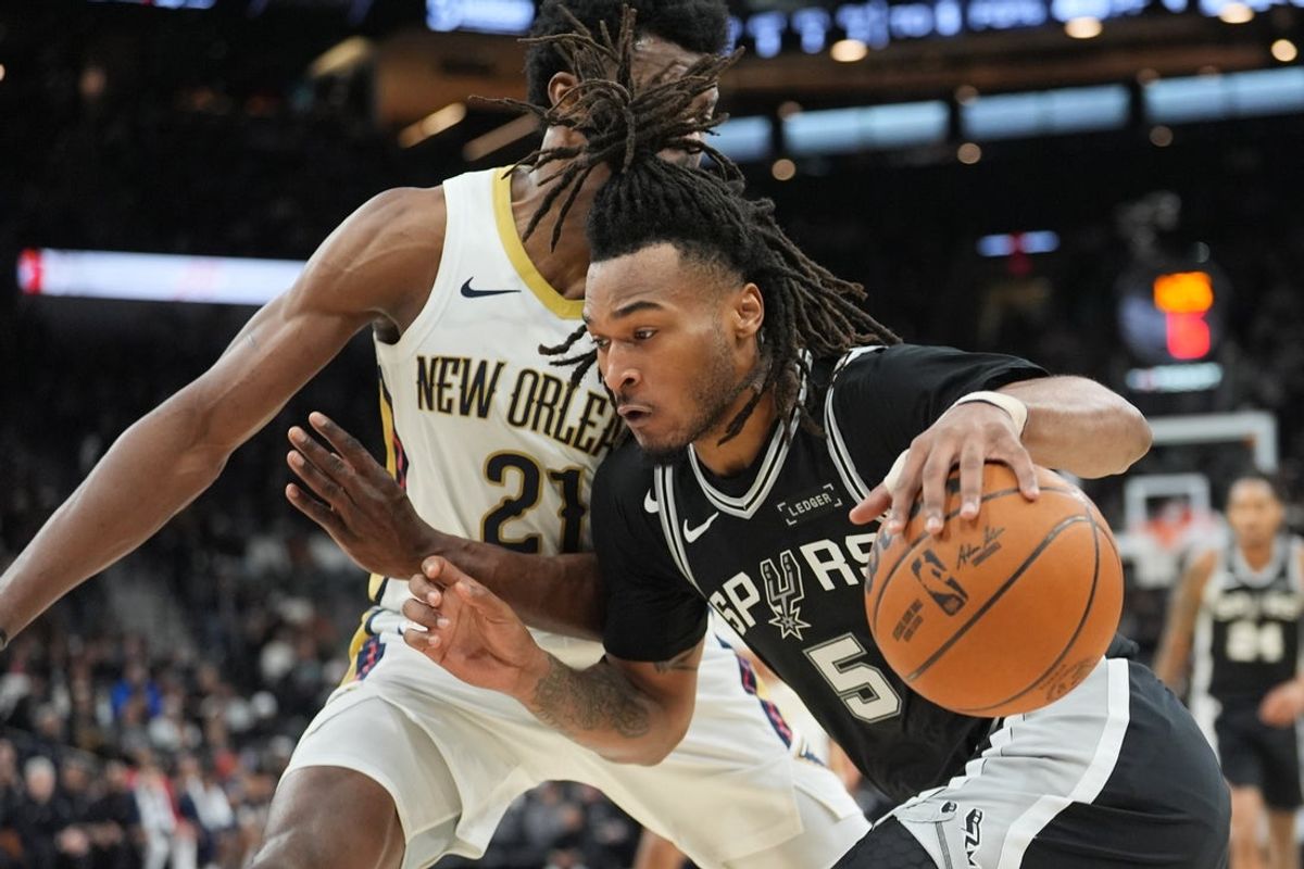 Jan 25, 2026; San Antonio, Texas, USA;  San Antonio Spurs guard Stephon Castle (5) dribbles against New Orleans Pelicans center Yves Missi (21) in the first half at Frost Bank Center. Mandatory Credit: Daniel Dunn-Imagn Images