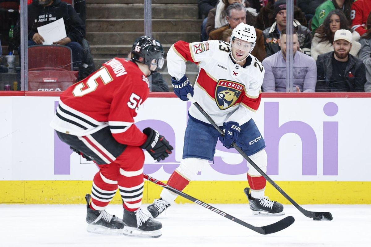 Jan 25, 2026; Chicago, Illinois, USA; Florida Panthers center Carter Verhaeghe (23) shoots against Chicago Blackhawks defenseman Artyom Levshunov (55) during the second period at United Center. Mandatory Credit: Kamil Krzaczynski-Imagn Images