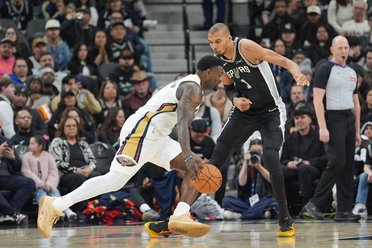 Jan 25, 2026; San Antonio, Texas, USA;  New Orleans Pelicans forward Zion Williamson (1) dribbles against San Antonio Spurs forward Victor Wembanyama (1) in the first half at Frost Bank Center. Mandatory Credit: Daniel Dunn-Imagn Images