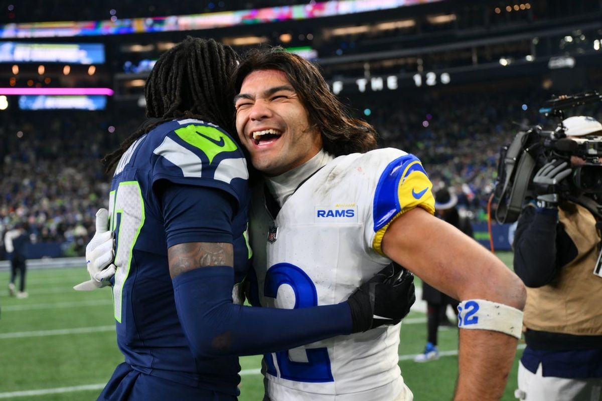 Jan 25, 2026; Seattle, WA, USA; Seattle Seahawks cornerback Riq Woolen (27) and Los Angeles Rams wide receiver Puka Nacua (12) embrace after the 2026 NFC Championship Game at Lumen Field. Mandatory Credit: Steven Bisig-Imagn Images