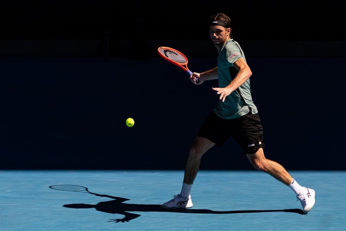 Jan 26, 2026; Melbourne, Victoria, Australia; Taylor Fritz of United States in action against Lorenzo Musetti of Italy in the fourth round of the menís singles at the Australian Open at Rod Laver Arena in Melbourne Park. Mandatory Credit: Mike Frey-Imagn Images