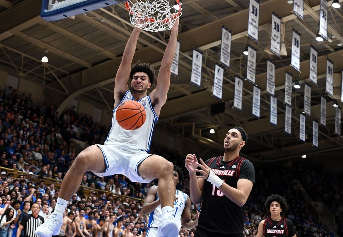 Jan 26, 2026; Durham, North Carolina, USA; Duke Blue Devils forward Cameron Boozer (12) dunks in front of Louisville Cardinals center Aly Khalifa (15) during the second half at Cameron Indoor Stadium. Mandatory Credit: Rob Kinnan-Imagn Images