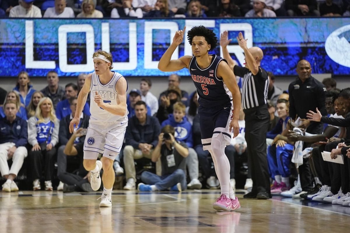 Jan 26, 2026; Provo, Utah, USA; Arizona Wildcats guard Brayden Burries (5) reacts to a three-pointer during the first half against the BYU Cougars at Marriott Center. Mandatory Credit: Aaron Baker-Imagn Images