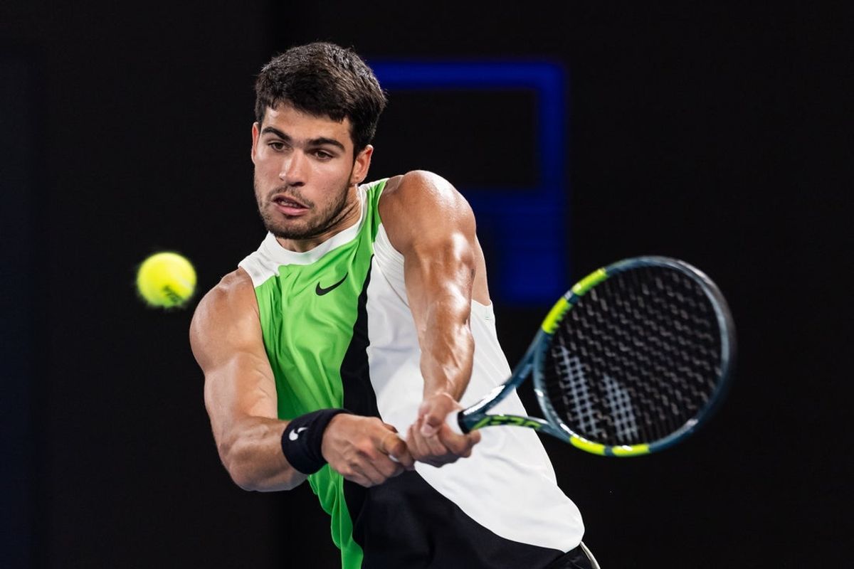 Jan 27, 2026; Melbourne, Victoria, Australia; Carlos Alcaraz of Spain in action against Alex de Minaur of Australia in the quarterfinals of the men’s singles at the Australian Open at Rod Laver Arena in Melbourne Park. Mandatory Credit: Mike Frey-Imagn Images