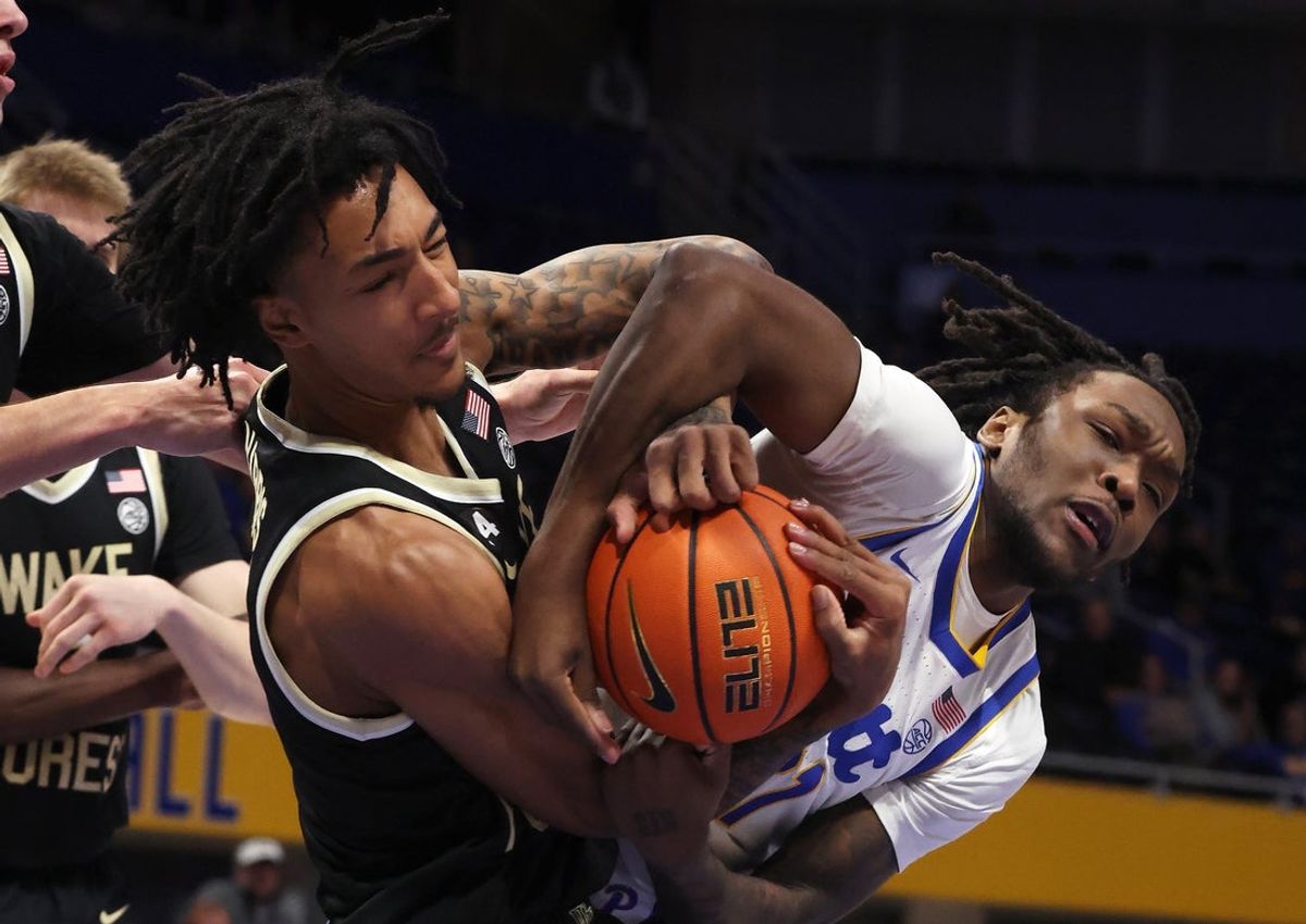 Jan 27, 2026; Pittsburgh, Pennsylvania, USA; Wake Forest Demon Deacons forward Juke Harris (left) and Pittsburgh Panthers guard MacAri Moore (right) fight for a rebound during the first half at the Petersen Events Center. Mandatory Credit: Charles LeClaire-Imagn Images