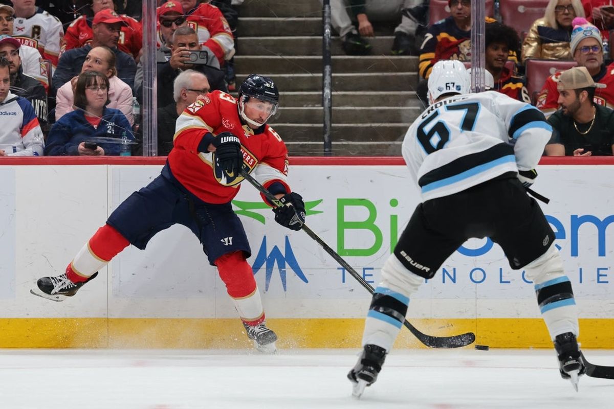 Jan 27, 2026; Sunrise, Florida, USA; Florida Panthers left wing Brad Marchand (63) moves the puck as Utah Mammoth left wing Lawson Crouse (67) defends during the first period at Amerant Bank Arena. Mandatory Credit: Sam Navarro-Imagn Images