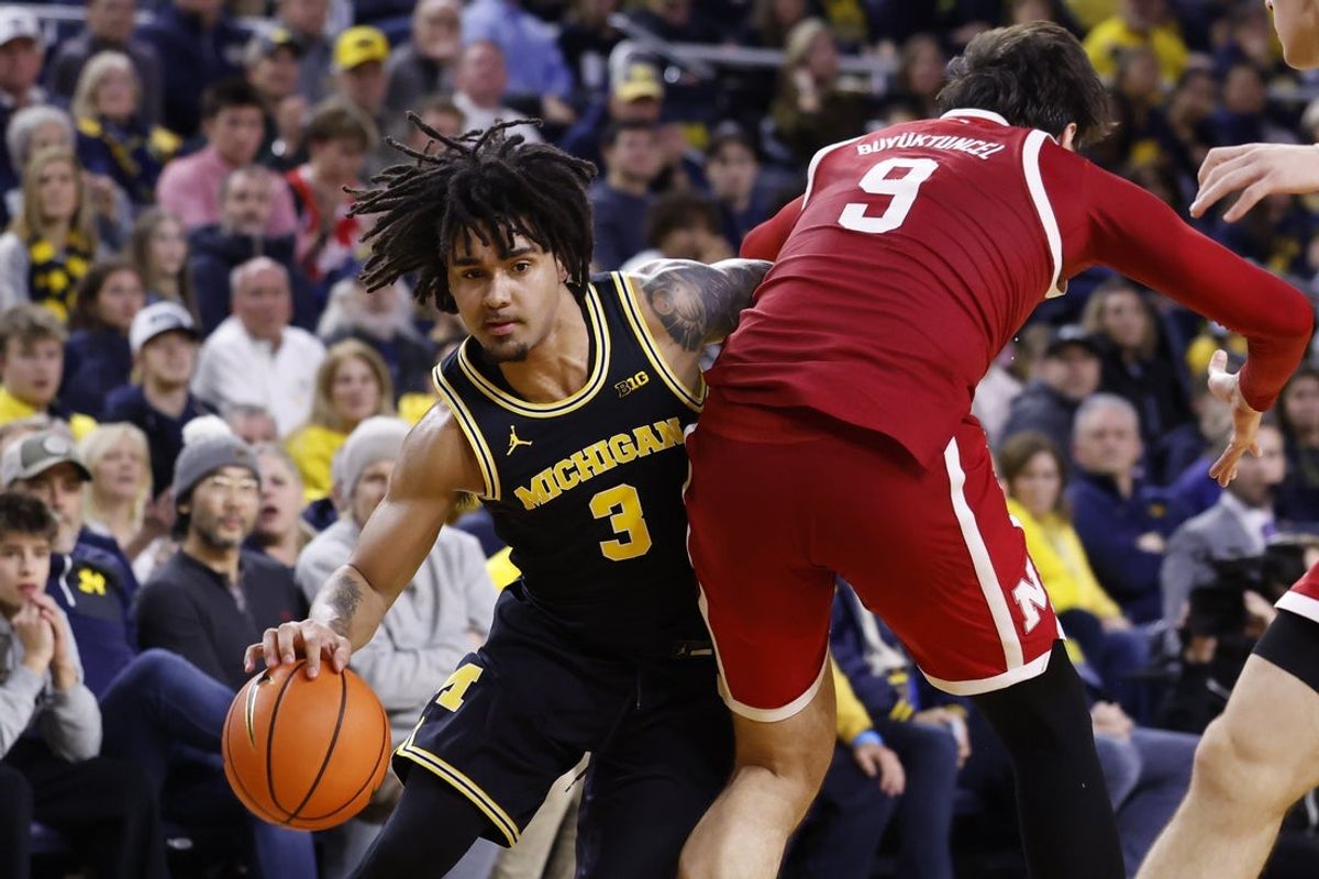 Jan 27, 2026; Ann Arbor, Michigan, USA;  Michigan Wolverines guard Elliot Cadeau (3) dribbles defended by Nebraska Cornhuskers forward Berke Buyuktuncel (9) in the first half at Crisler Center. Mandatory Credit: Rick Osentoski-Imagn Images