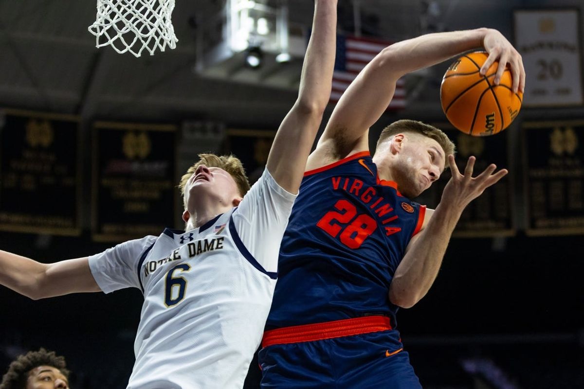 Jan 27, 2026; South Bend, Indiana, USA; Virginia Cavaliers forward Thijs de Ridder (28) grabs a rebound away from Notre Dame Fighting Irish forward Brady Koehler (6) during the first half at Purcell Pavilion at the Joyce Center. Mandatory Credit: Michael Caterina-Imagn Images