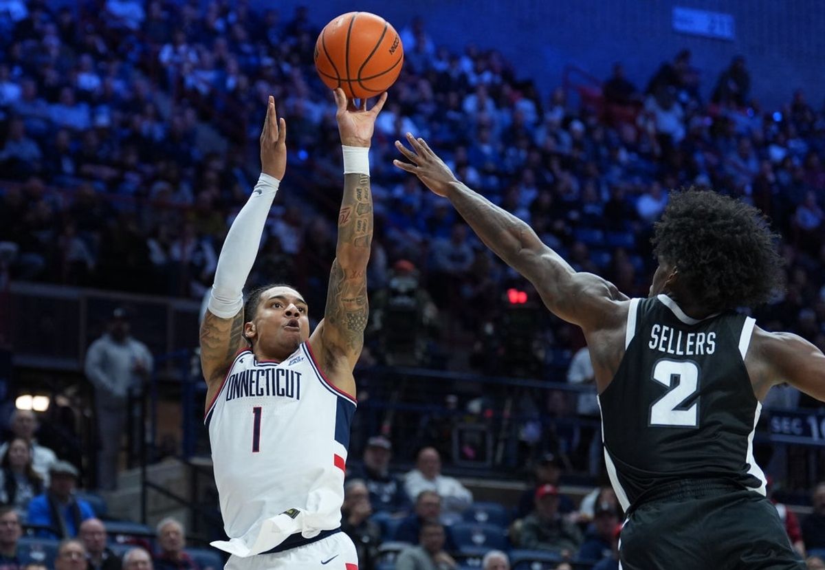Jan 27, 2026; Storrs, Connecticut, USA; UConn Huskies guard Solo Ball (1) shoots the ball against Providence Friars guard Jaylin Sellers (2) in the first half at Harry A. Gampel Pavilion. Mandatory Credit: David Butler II-Imagn Images