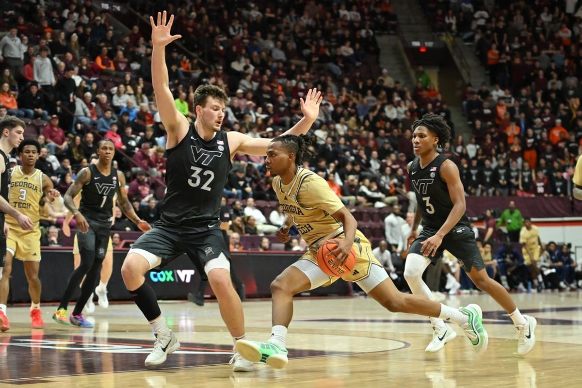 Jan 27, 2026; Blacksburg, Virginia, USA; Georgia Tech Yellow Jackets guard Lamar Washington (1) drives toward the basket as Virginia Tech Hokies center Christian Gurdak (32) defends during the first half at Cassell Coliseum. Mandatory Credit: Brian Bishop-Imagn Images