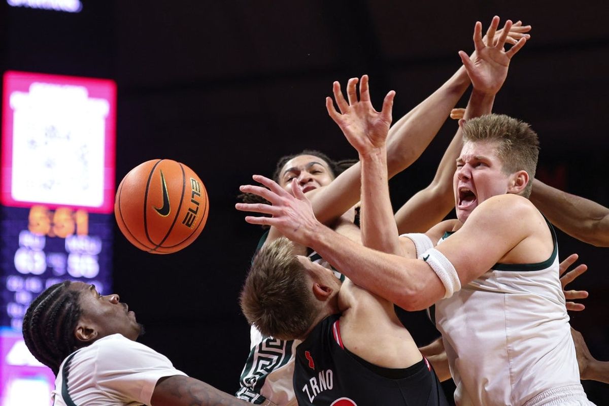 Jan 27, 2026; Piscataway, New Jersey, USA; Rutgers Scarlet Knights guard Harun Zrno (13) rebounds against Michigan State Spartans forward Jordan Scott (6) and forward Jaxon Kohler (0) during the second half at Jersey Mike's Arena. Mandatory Credit: Vincent Carchietta-Imagn Images