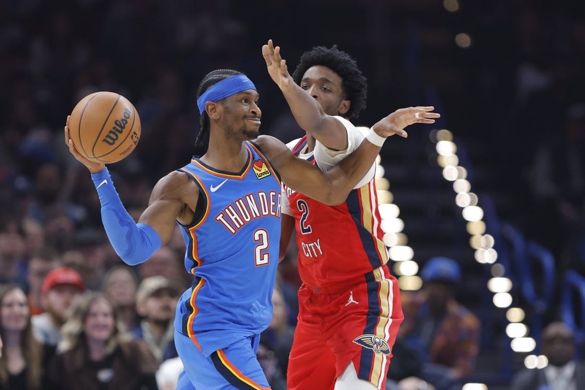 Jan 27, 2026; Oklahoma City, Oklahoma, USA; Oklahoma City Thunder guard Shai Gilgeous-Alexander (2) passes as New Orleans Pelicans forward Herbert Jones (2) defends during the second quarter at Paycom Center. Mandatory Credit: Alonzo Adams-Imagn Images