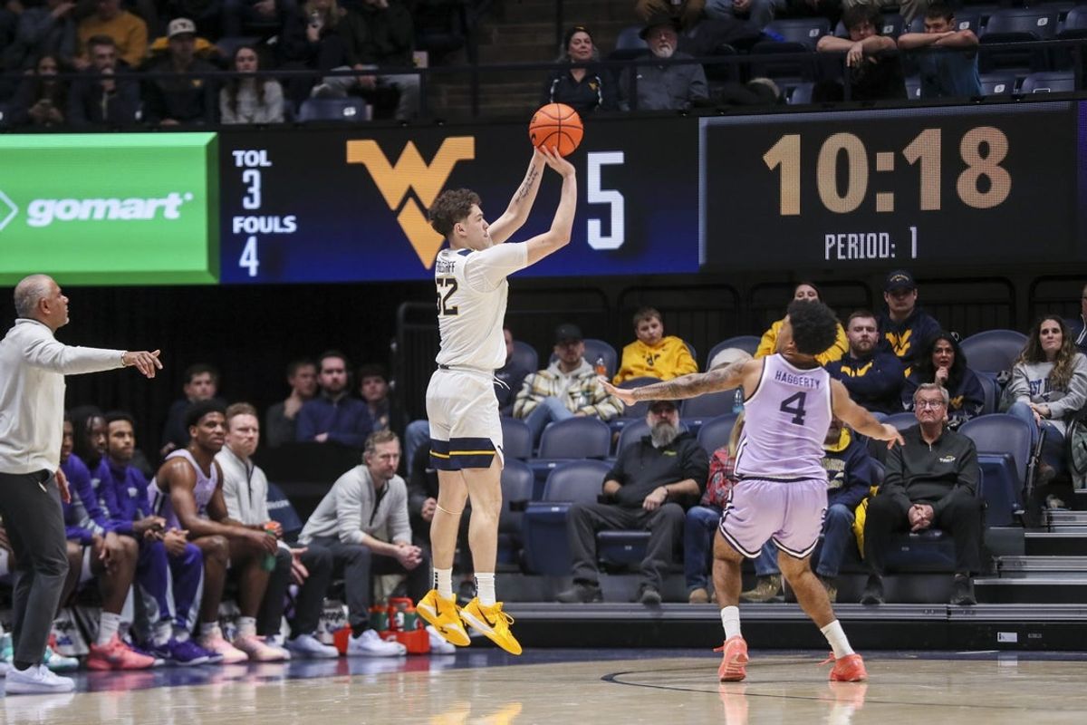 Jan 27, 2026; Morgantown, West Virginia, USA; West Virginia Mountaineers guard Treysen Eaglestaff (52) shoots a three pointer during the first half against the Kansas State Wildcats at Hope Coliseum. Mandatory Credit: Ben Queen-Imagn Imagesa