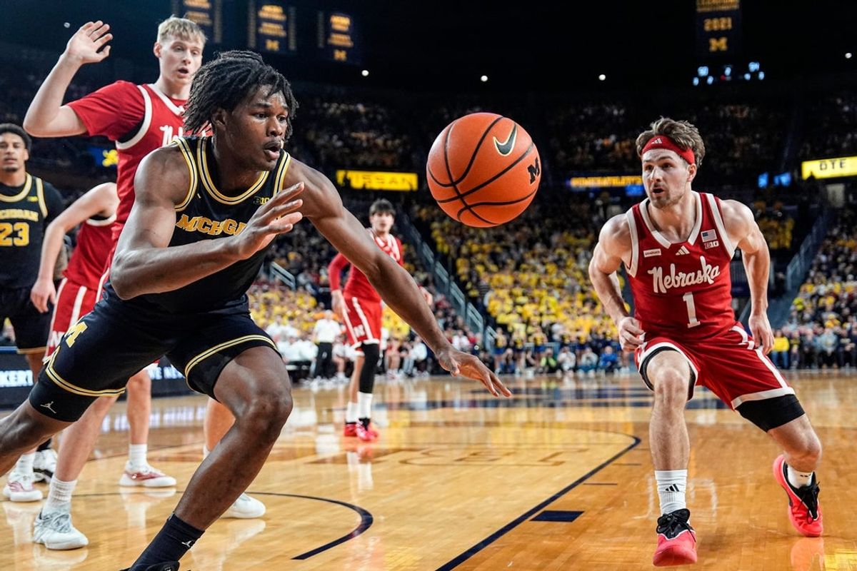 Michigan forward Morez Johnson Jr. (21) and Nebraska guard Sam Hoiberg (1) battle for a rebound during the second half at Crisler Center in Ann Arbor on Tuesday, Jan. 27, 2026.
