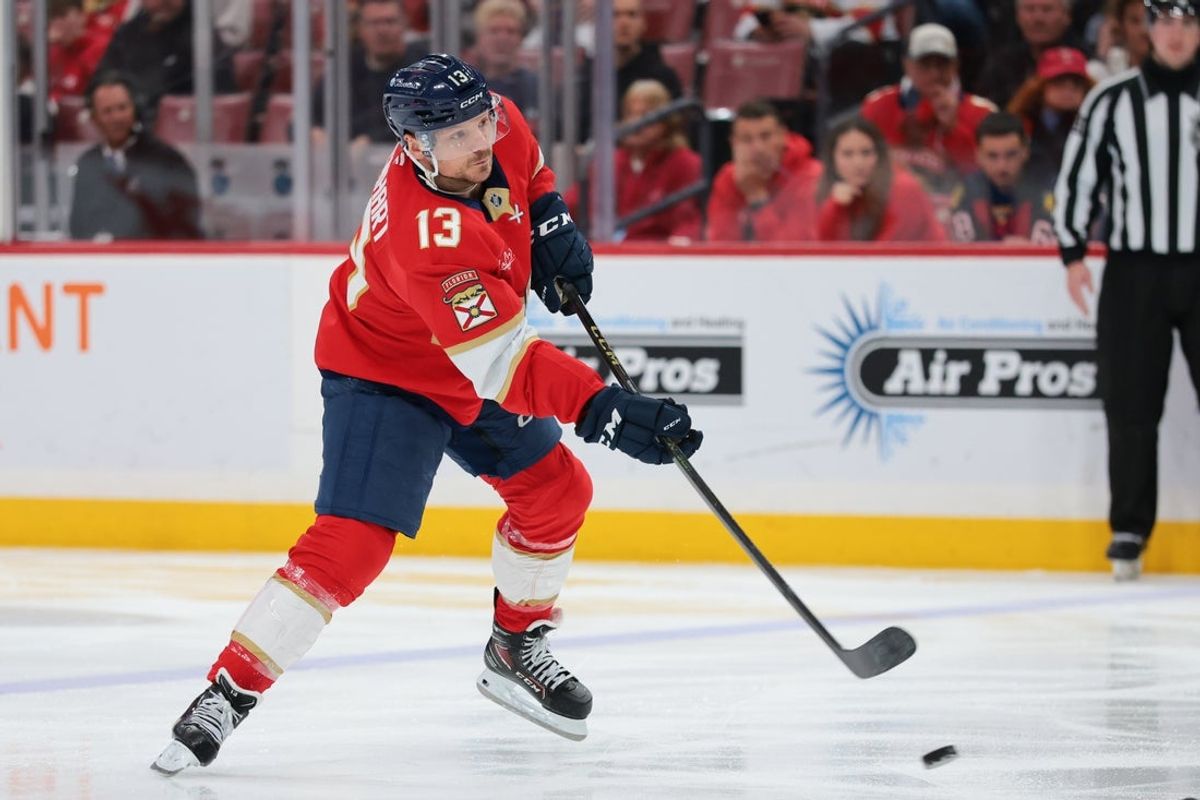 Jan 27, 2026; Sunrise, Florida, USA; Florida Panthers center Sam Reinhart (13) moves the puck against the Utah Mammoth during the third period at Amerant Bank Arena. Mandatory Credit: Sam Navarro-Imagn Images