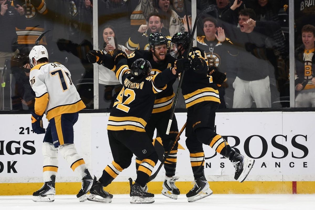 Jan 27, 2026; Boston, Massachusetts, USA; As Nashville Predators defenseman Brady Skjei (76) skates away, Boston Bruins right wing David Pastrnak (88) is congratulated by teammates center Marat Khusnutdinov (92) and defenseman Charlie McAvoy (73) after scoring the winning goal in overtime at TD Garden. Mandatory Credit: Winslow Townson-Imagn Images