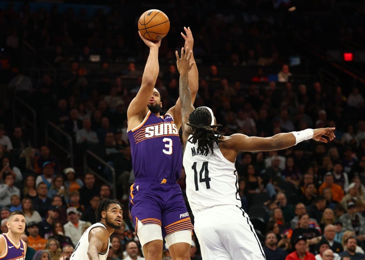 Jan 27, 2026; Phoenix, Arizona, USA; Phoenix Suns forward Dillon Brooks (3) shoots the ball against Brooklyn Nets guard Terance Mann (14) in the first half at Mortgage Matchup Center. Mandatory Credit: Mark J. Rebilas-Imagn Images