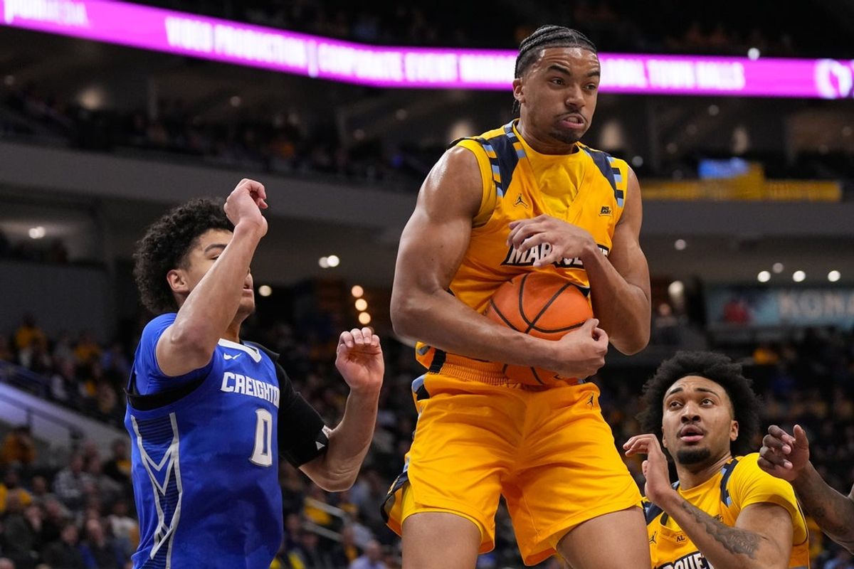 Jan 27, 2026; Milwaukee, Wisconsin, USA;  Marquette Golden Eagles forward Royce Parham (13) grabs a rebound during the first half against the Creighton Bluejays at Fiserv Forum. Mandatory Credit: Jeff Hanisch-Imagn Images