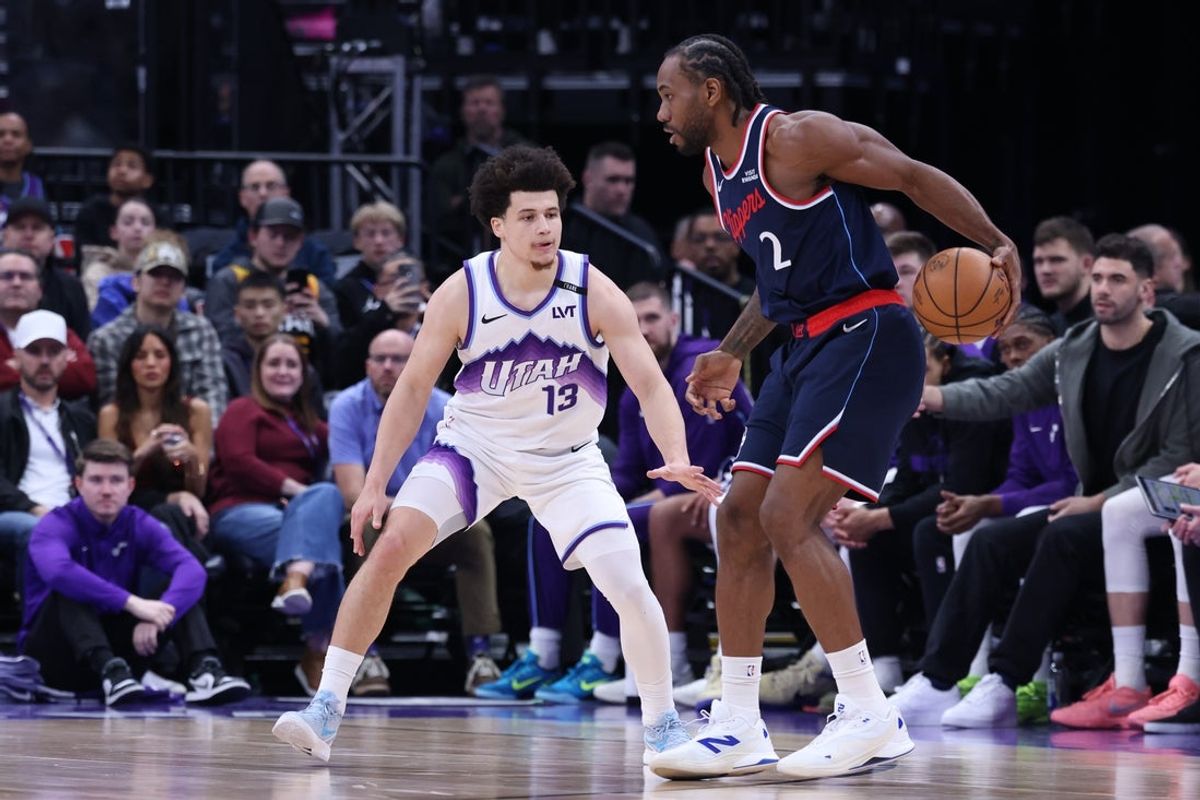 Jan 27, 2026; Salt Lake City, Utah, USA; LA Clippers forward Kawhi Leonard (2) dribbles the ball as Utah Jazz guard Walter Clayton Jr. (13) defends during the first half at Delta Center. Mandatory Credit: Rob Gray-Imagn Images