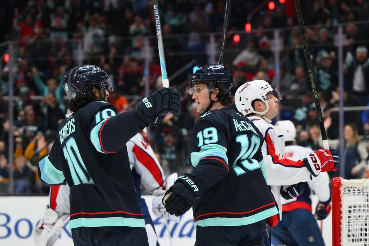 Jan 27, 2026; Seattle, Washington, USA; Seattle Kraken center Matty Beniers (10) and Seattle Kraken left wing Jared McCann (19) celebrate a goal scored by McCann during the second period against the Washington Capitals at Climate Pledge Arena. Mandatory Credit: Steven Bisig-Imagn Images