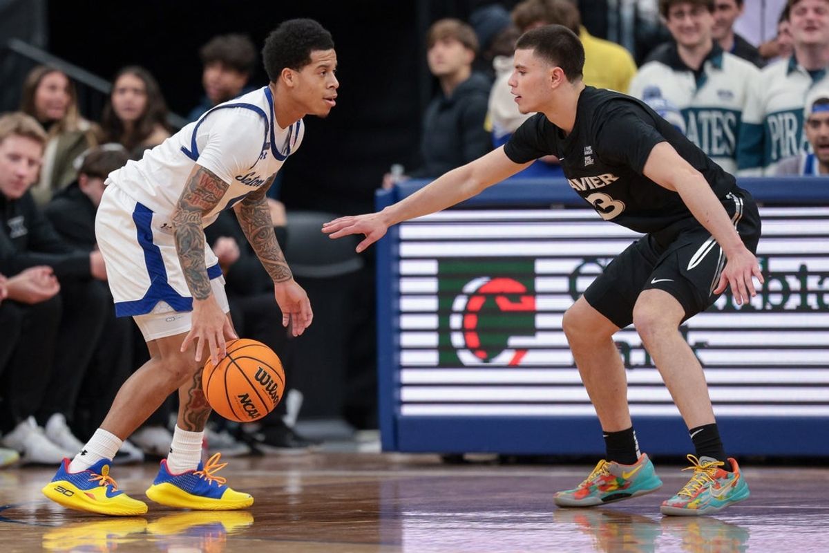 Jan 28, 2026; Newark, New Jersey, USA; Seton Hall Pirates guard Adam Clark (0) is guarded by Xavier Musketeers guard All Wright (3) during the first half at Prudential Center. Mandatory Credit: Vincent Carchietta-Imagn Images