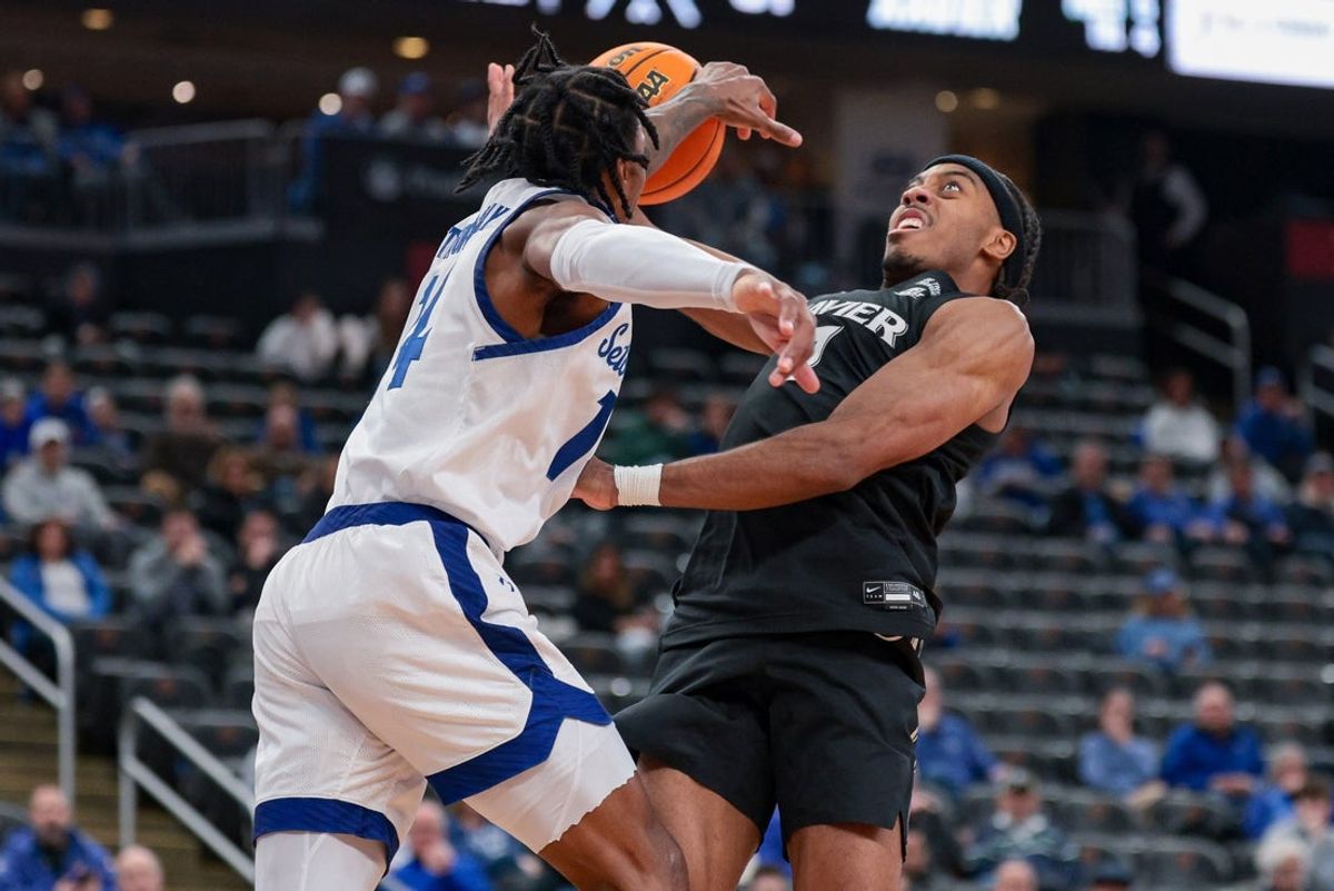 Jan 28, 2026; Newark, New Jersey, USA; Seton Hall Pirates guard A.J. Staton-McCray (14) blocks a shot by by Xavier Musketeers guard Isaiah Walker (7) during the first half at Prudential Center. Mandatory Credit: Vincent Carchietta-Imagn Images