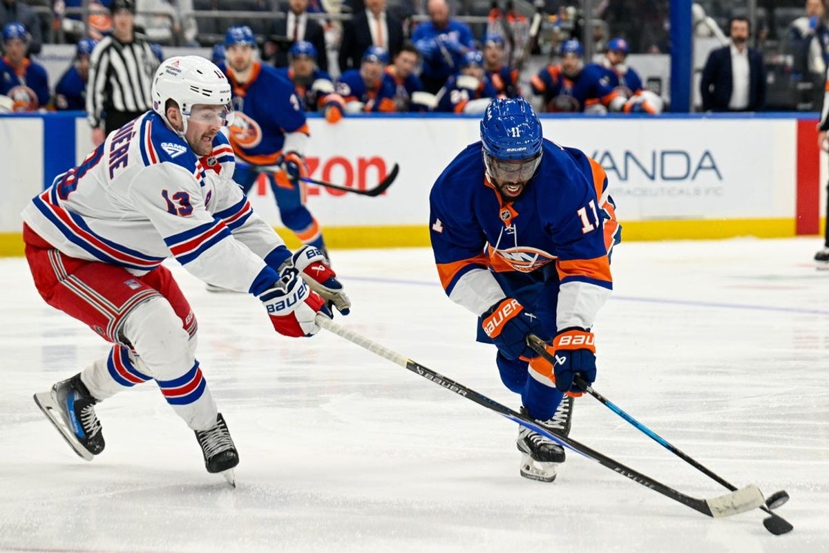 Jan 28, 2026; Elmont, New York, USA;  New York Rangers left wing Alexis Lafrenière (13) defends against New York Islanders left wing Anthony Duclair (11) during the second period at UBS Arena. Mandatory Credit: Dennis Schneidler-Imagn Images