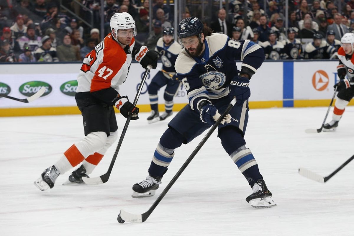 Jan 28, 2026; Columbus, Ohio, USA; Columbus Blue Jackets right wing Kirill Marchenko (86) carries the puckas Philadelphia Flyers defenseman Noah Juulsen (47) defends during the second period at Nationwide Arena. Mandatory Credit: Russell LaBounty-Imagn Images