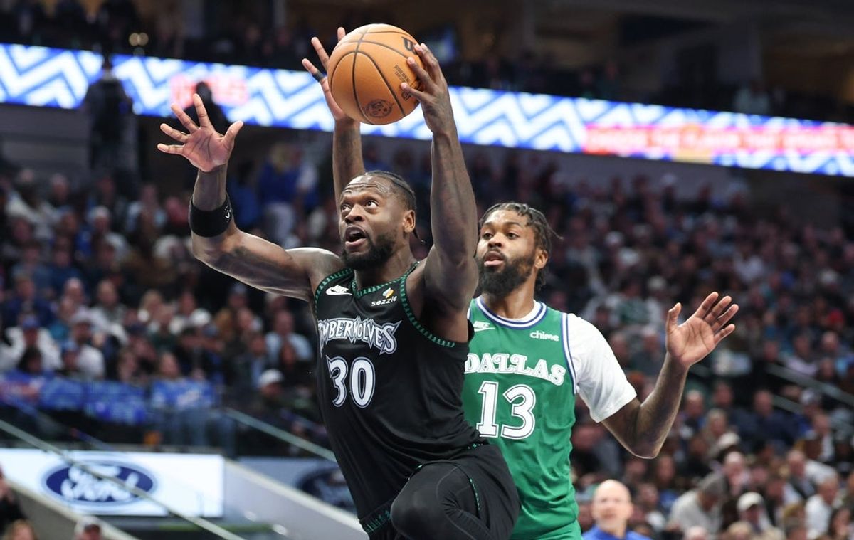 Jan 28, 2026; Dallas, Texas, USA;  Minnesota Timberwolves forward Julius Randle (30) drives to the basket as Dallas Mavericks forward Naji Marshall (13) defends at American Airlines Center. Mandatory Credit: Kevin Jairaj-Imagn Images